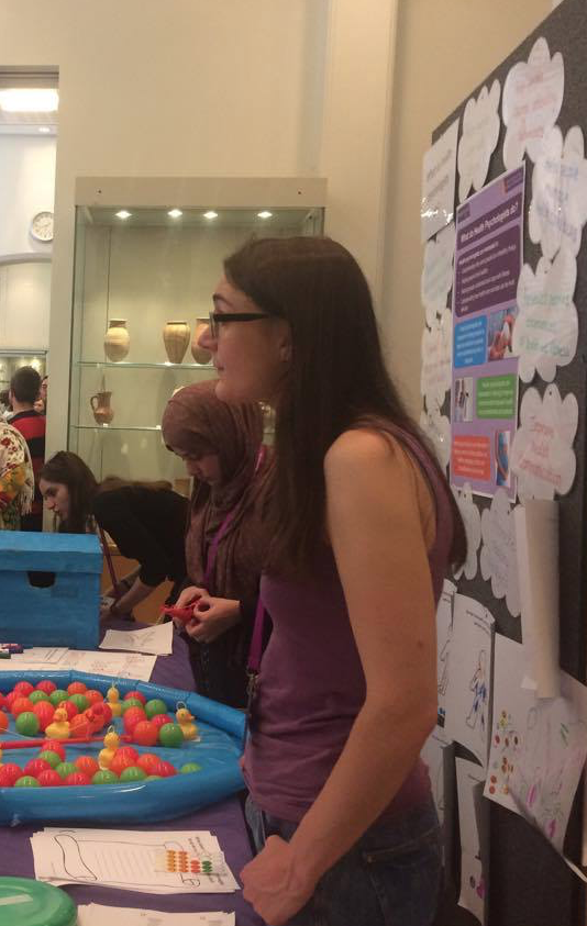 Kiera talking to a visitor about the research we do at MCHP