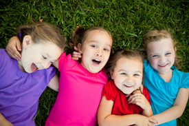 Four girls lying on grass